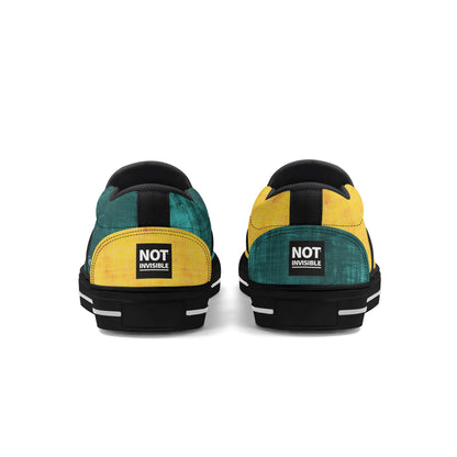 Pair of green and yellow sneakers with 'Not Invisible' label on a white background
