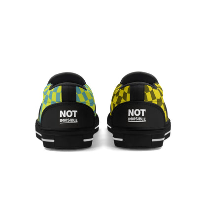 Black sneakers with colorful patterned sides and 'NOT INVISIBLE' text on a white background