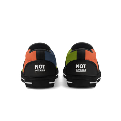 Black sneakers with multicolor accents and 'NOT INVISIBLE' text on a white background